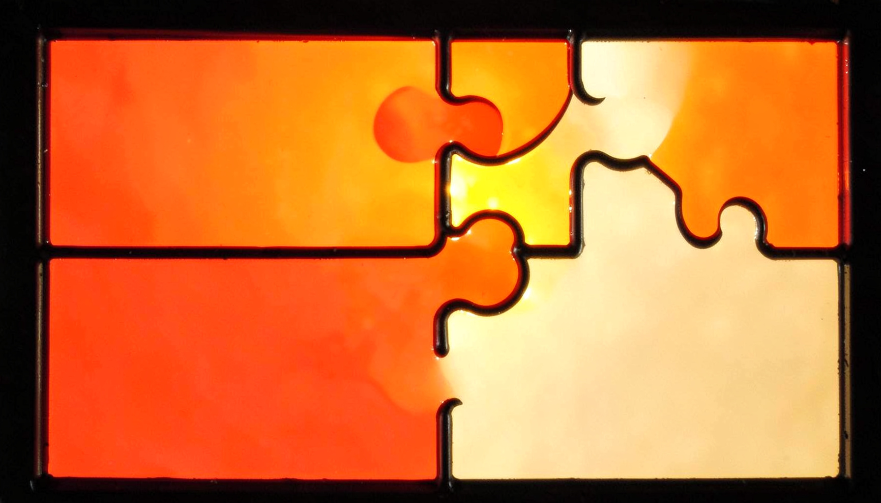 A stained-glass composition with bold leaded segments in bright coral, tangerine, and soft cream, evoking colorful puzzle pieces fitting together